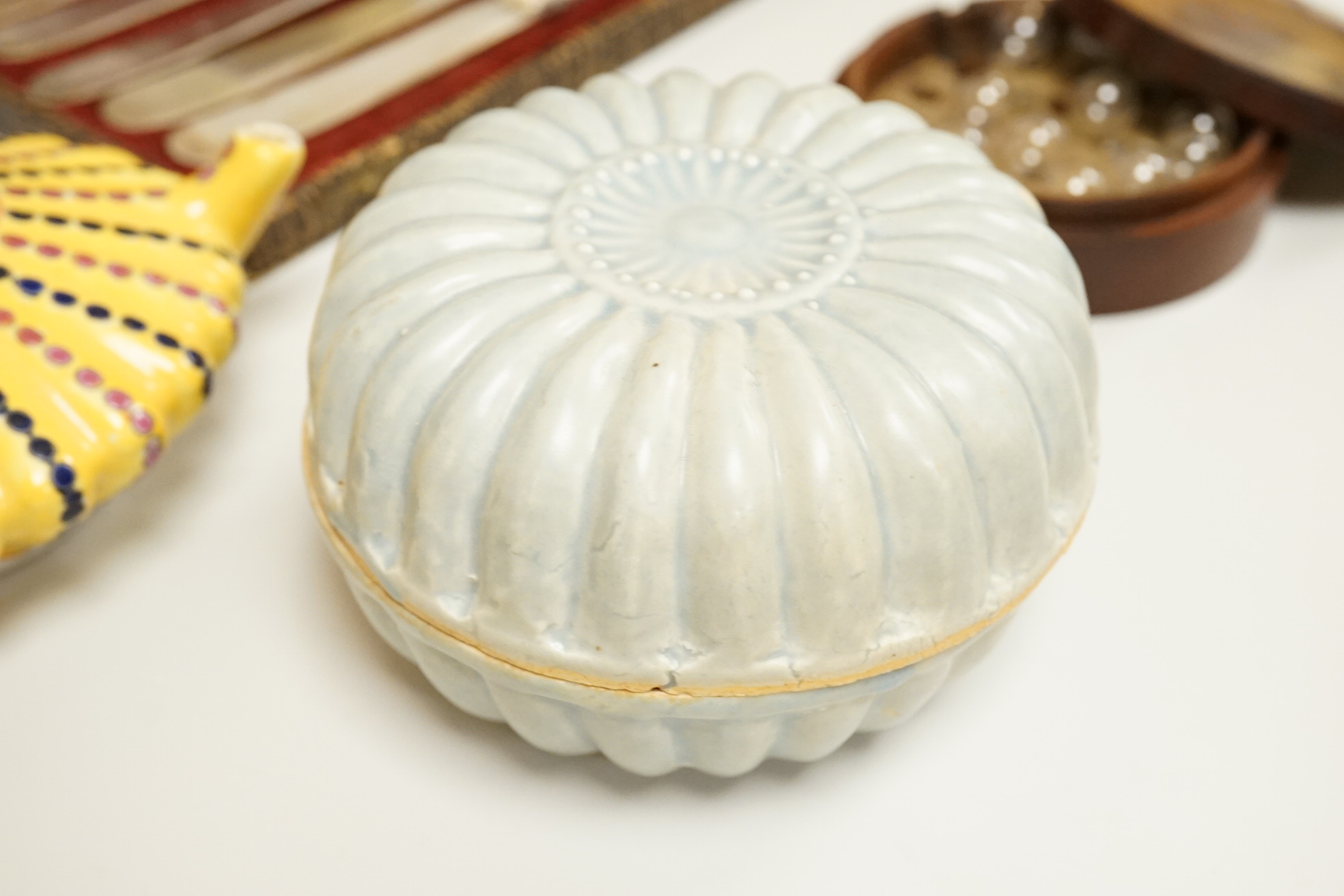 A cased set of semi-precious handled butter knives, two Chinese pottery teapots, a stoneware box and a figure, etc.